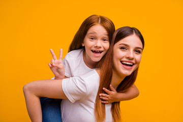 Sticker - Close-up portrait of two nice-looking attractive lovely cheerful cheery glad playful person having fun free time holiday weekend showing v-sign isolated over bright vivid shine yellow background