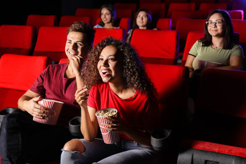 Sticker - Couple with popcorn watching movie in cinema