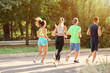 © Pixel-Shot - Group of sporty young people running outdoors