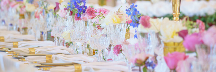 Banquet table set with silverware, napkin and glass at restaurant before party