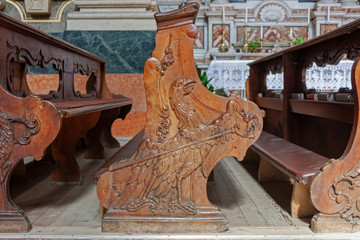 detail of the carved wooden benches of the cathedral of Bressanone, depicting the eagle with pastoral, emblem of the Chapter of the Cathedral.