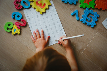 Wall Mural - little girl learning write and culculate numbers