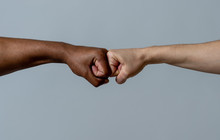 Fist Of Different Skin Colors Giving Fist Bump. Conceptual Image Of Race Tolerance And Stop Racism
