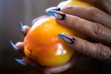 Wall Mural - Females hands with manicured nails holds fresh organic paprika