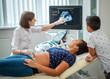 © Nejron Photo - Pregnant woman and her son on utltrasonographic examination at hospital