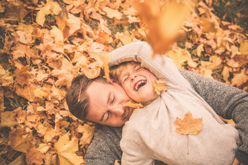 Poster - Papa mit Sohn tobt im Laub 