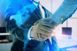 © Andrey - Multi exposure of world map on office background with two businessmen handshake. Concept of international business