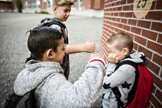 sad intimidation moment elementary age bullying in schoolyard