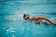 © primipil - Young woman swimmer swims in swimming pool