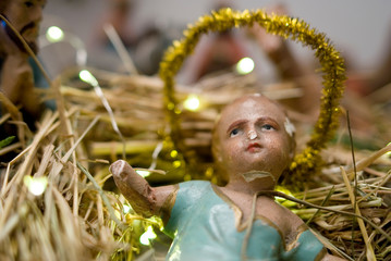 Christmas nativity scene, old hand-painted plaster figurine, jesus in foreground, religion, prayers, birth, christianity, holiday, lights, Italy