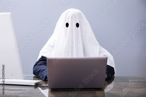 Fotomural Ghostwriter Writing Article On Laptop