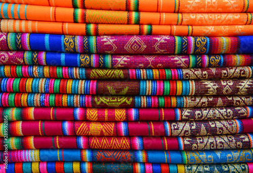 Cuadros en Lienzo A pile of colorful traditional textiles in the Andes mountain range sunday market of Otavalo, north of Quito, Ecuador