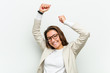 © Asier - Young european business woman celebrating a special day, jumps and raise her arms with energy.