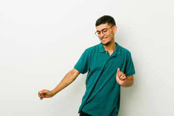 Young hispanic man dancing and having fun.