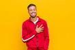 © Asier - Young filipino fitness man laughing keeping hands on heart, concept of happiness.