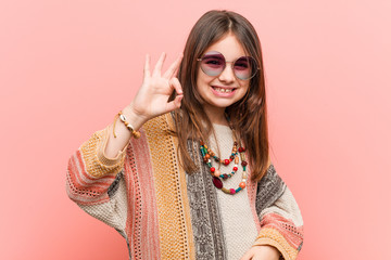 Wall Mural - Little hippie girl cheerful and confident showing ok gesture.