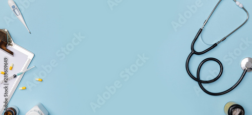 Fotomural Creative flatlay of doctor medical equipment blue table with stethoscope, medica
