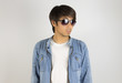 © steafpong - Young Asian Man in Jeans or Denim Jacket Wear Sunglasses Looking 45 Degree Pose