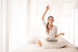 © Stock_ko - Girl relaxing holiday by listening to music on the bed. Girls working at home use laptops and the Internet.