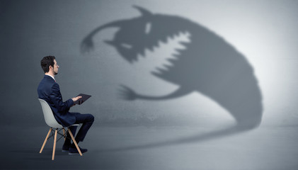 Wall Mural - Young businessman staying and negotiate with a monster shadow