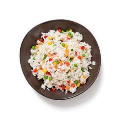 Bowl of rice with vegetables isolated on white background, top view.