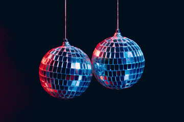 Wall Mural - Sparkling disco balls hanging in the air against black background