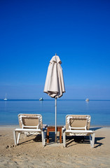 two chairs and umbrella on the beach