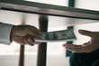 © wutzkoh - Entrepreneurs are receiving money under the desk that is a bribe of their partners with both of whom are corrupt in the company room.