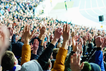 Wall Mural - Football fans clapping on the podium of the stadium