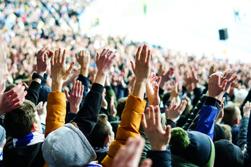 Wall Mural - Football fans clapping on the podium of the stadium