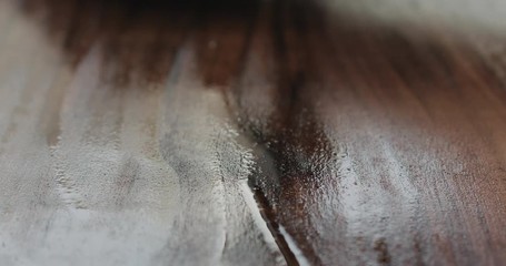 Poster - Slow motion woodworker applying oil finish to black walnut board