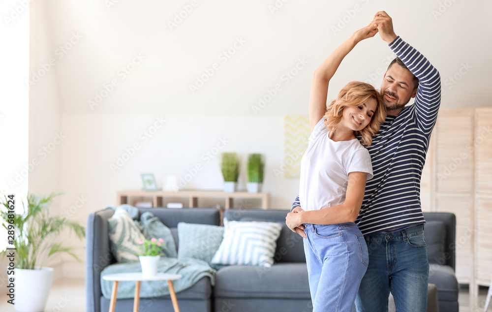 Happy dancing couple at home - obrazy, fototapety, plakaty 