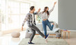 © Pixel-Shot - Happy young couple dancing at home