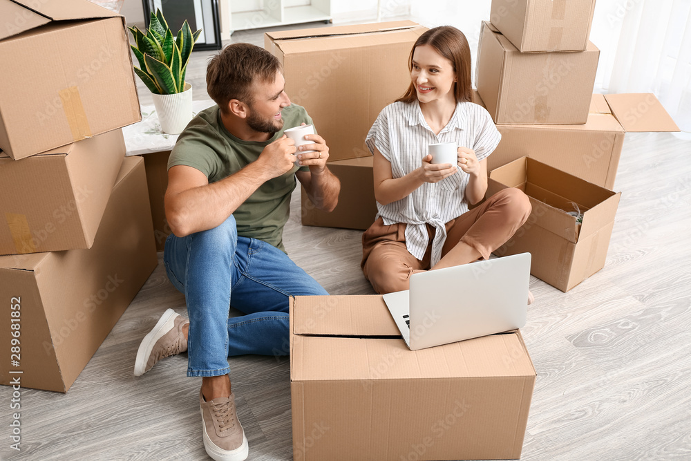 Young couple having break after moving into new house