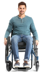 Handsome man in wheelchair on white background