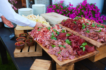 Wall Mural - Plate and board with assortment of delicious deli meats on table