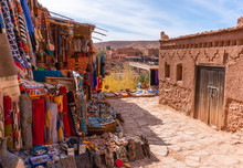 Streets In The Fortified Town Of Ait Ben Haddou Near Ouarzazate On The Edge Of The Sahara Desert In Morocco. Atlas Mountains. Street Local Ethnic Market With Goods And Carpets