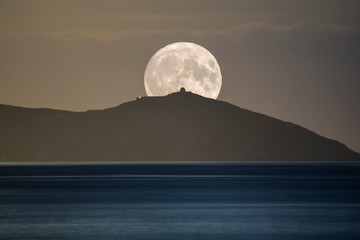 Wall Mural - harvest moon composite image, rising over rame head peninsula, cornwall, uk