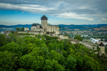 Wall Mural - Aerial panorama view of medieval newly restored Trencin castle over the Vah river in Slovakia  with dramatic sky