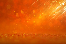 Background Of Gold And Orange Glitter Lights. De Focused