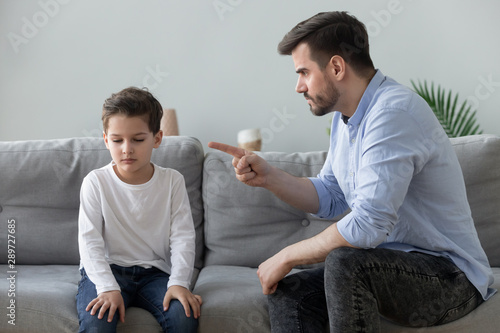 Fotografía Angry father scolding sad kid son for bad behavior