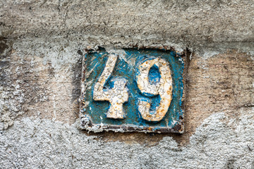 Street number sign on the wall