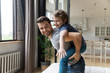© fizkes - Happy daddy giving piggyback ride to adorable son.
