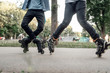 Roller skating, two male teenagers rolling in park