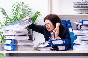 Middle-aged businesswoman unhappy with excessive work