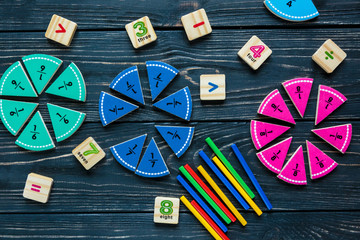 colorful math fractions on wooden background or table. interesting math for kids. Education, back to school concept. Geometry and mathematics materials.	