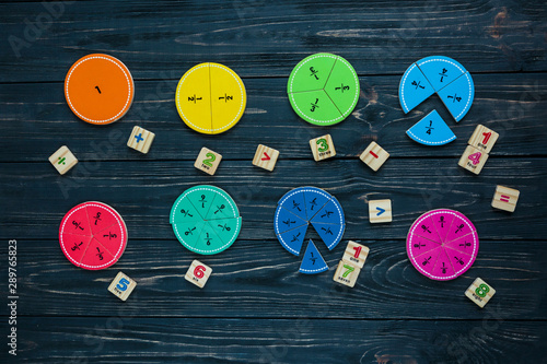 colorful math fractions on wooden background or table Fototapeta
