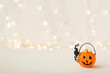 Halloween pumpkin with spider on a shiny light background