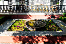 Old Street Historic Garden District In Louisiana City With Garden Water Fountain By House Patio Or Cast Iron Balcony In New Orleans, Louisiana