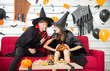© Arunporn - Happy Halloween party concept. Young man and woman wearing as vampires, witch or ghost celebrate the halloween festival